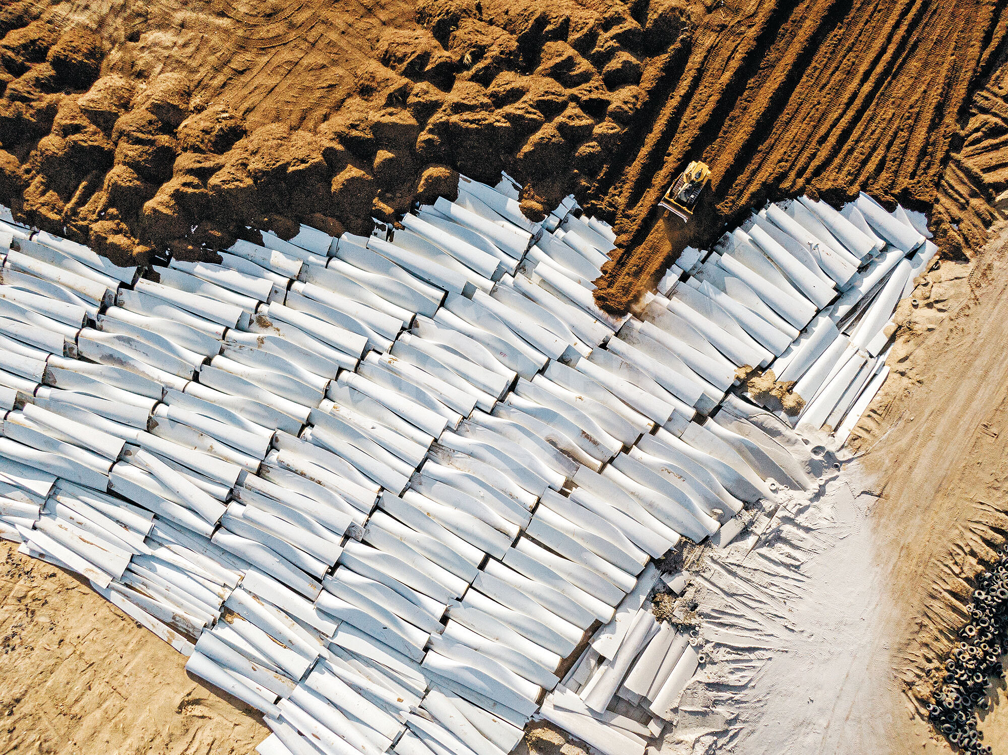 A decommissioned wind turbine blade section cut into transportable pieces